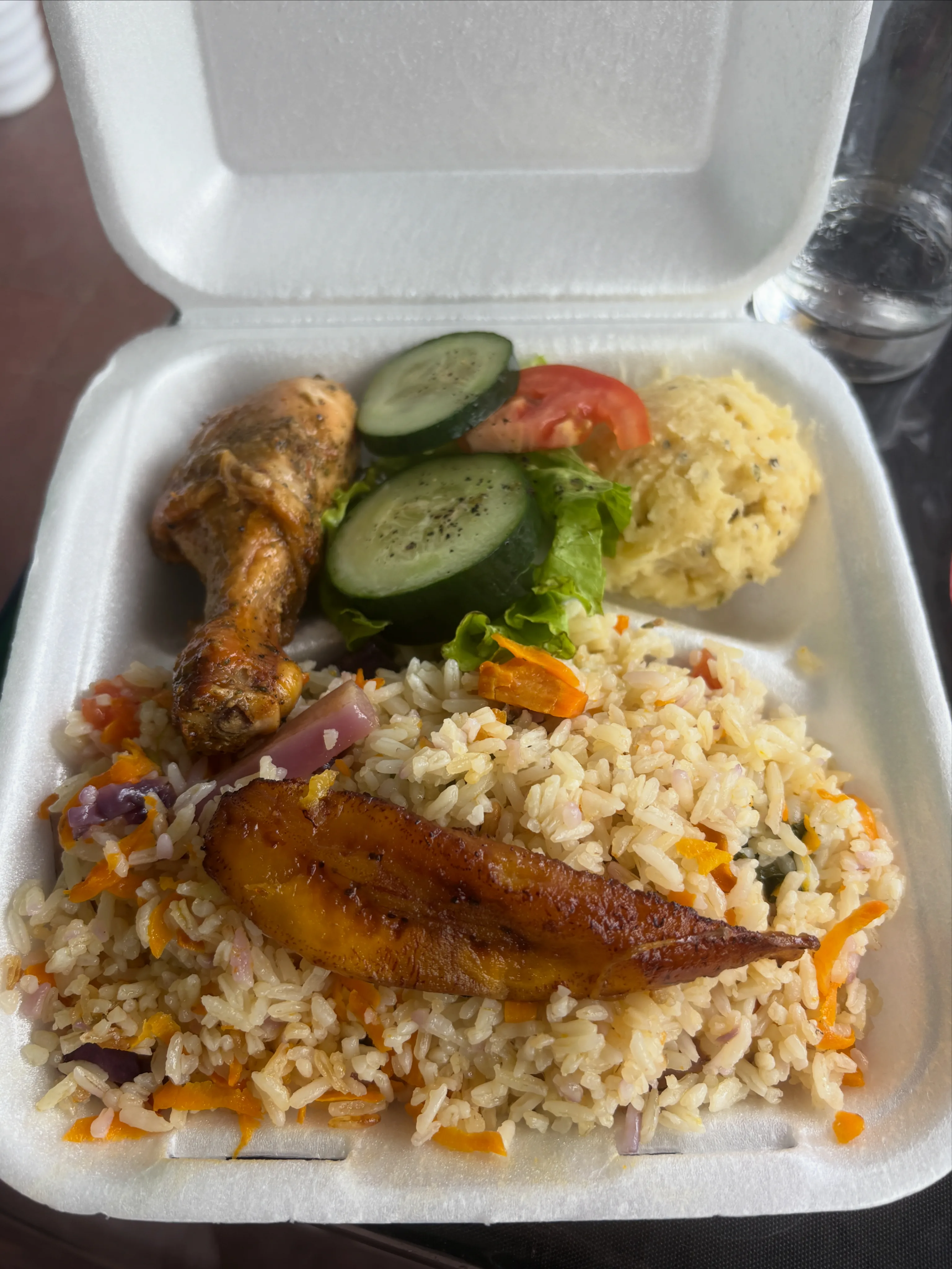 Caja para llevar con pollo, arroz, plátano, ensalada y puré de papa.